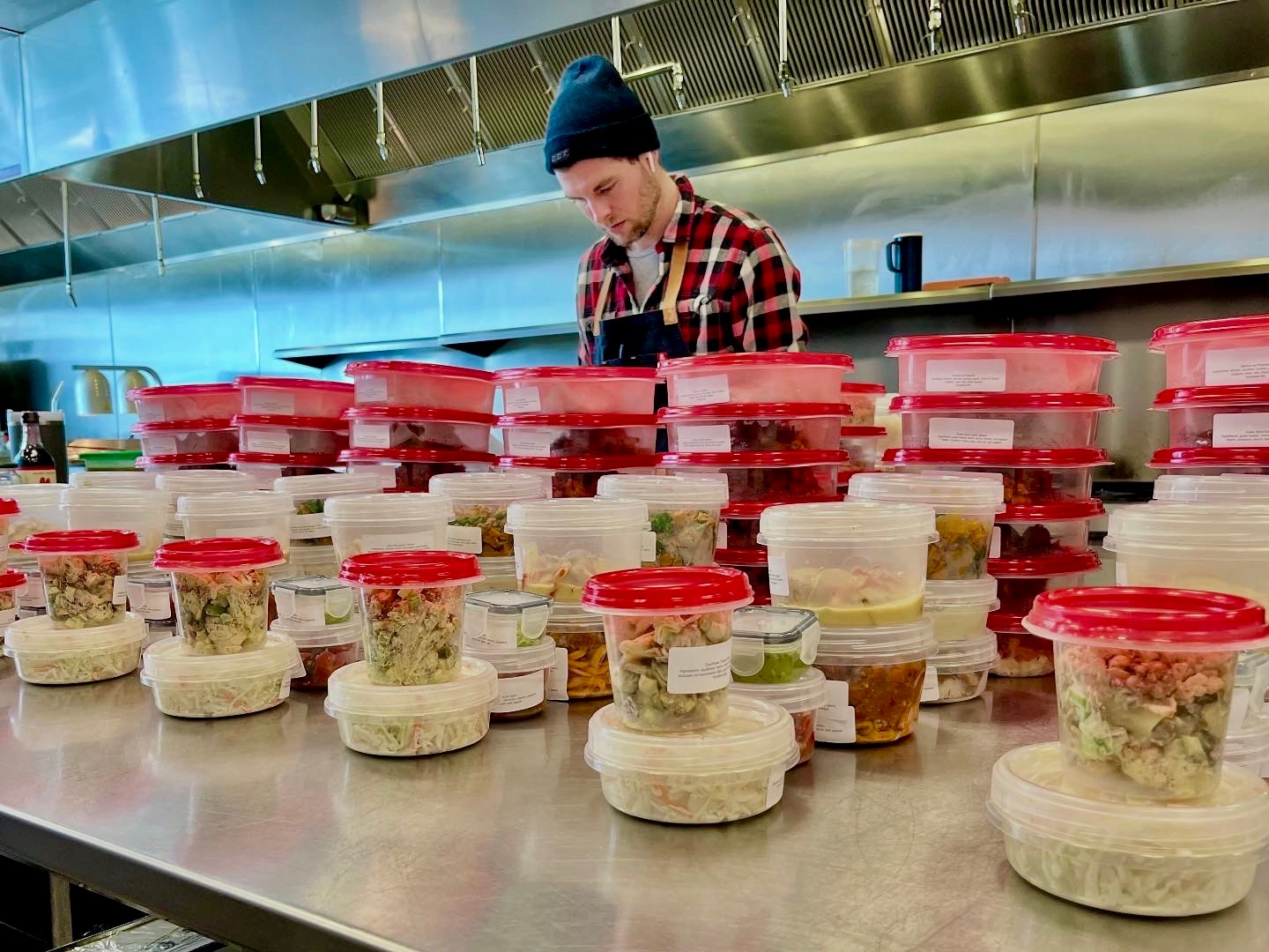 Chef Colton prepares to package meals.